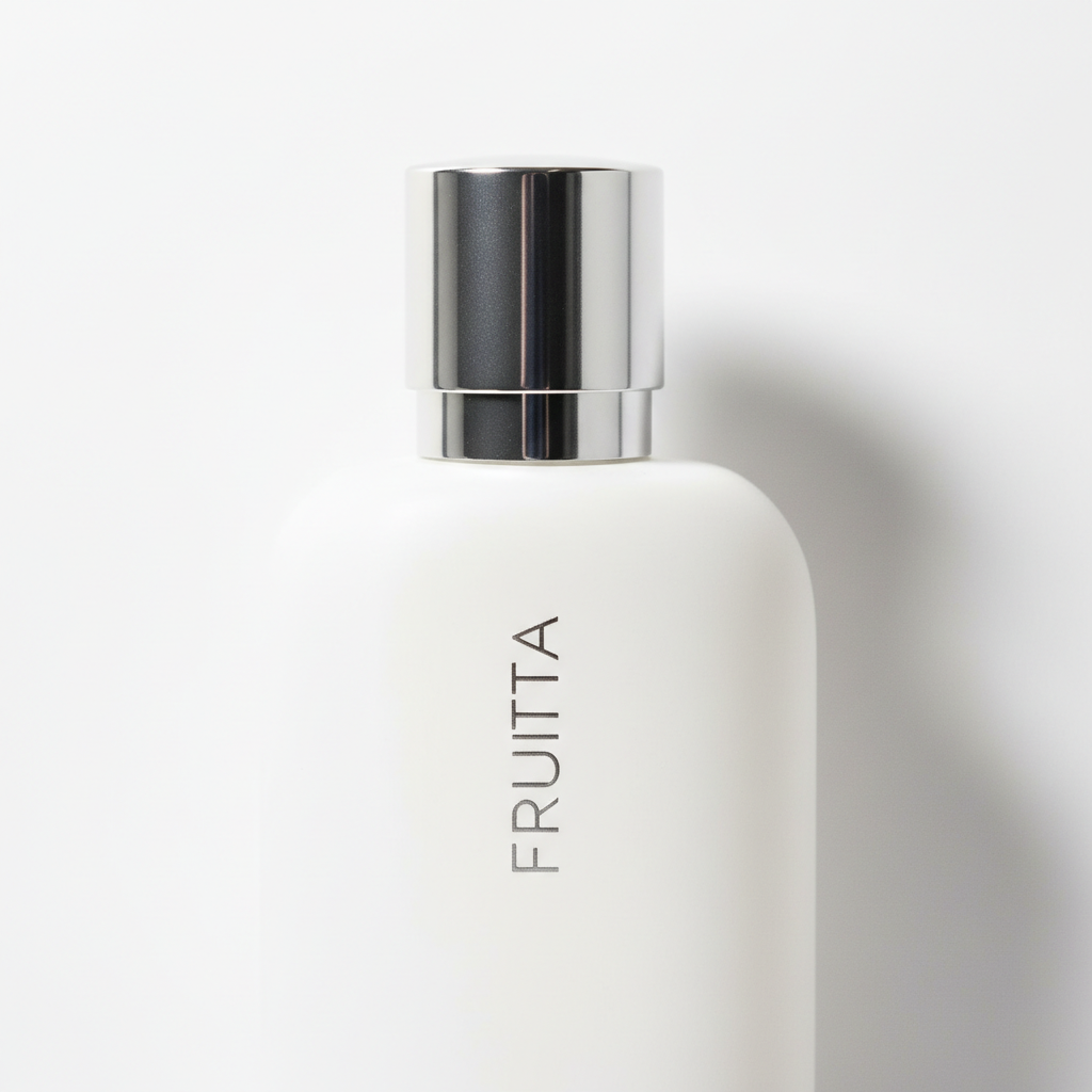Fruitta Eau de Parfum bottle on clean white background, editorial shot